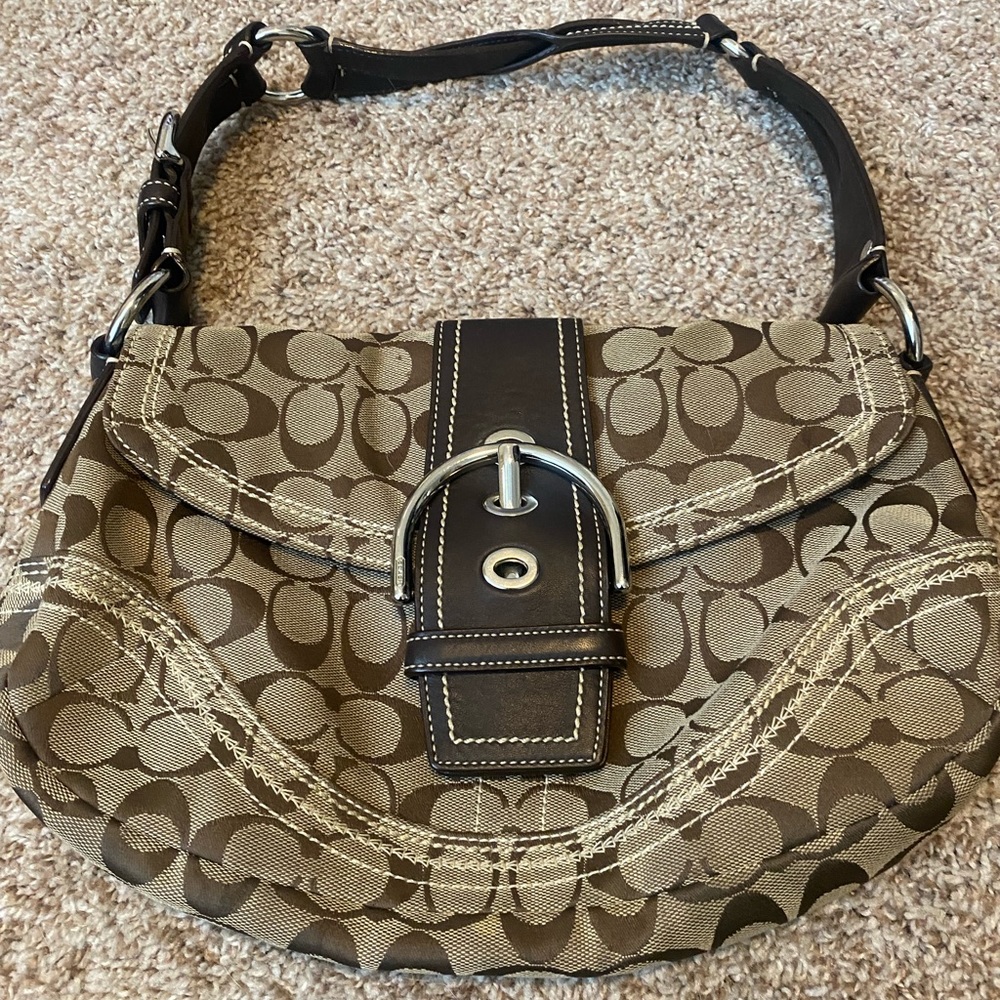Brown signature Coach handbag with silver hardware.